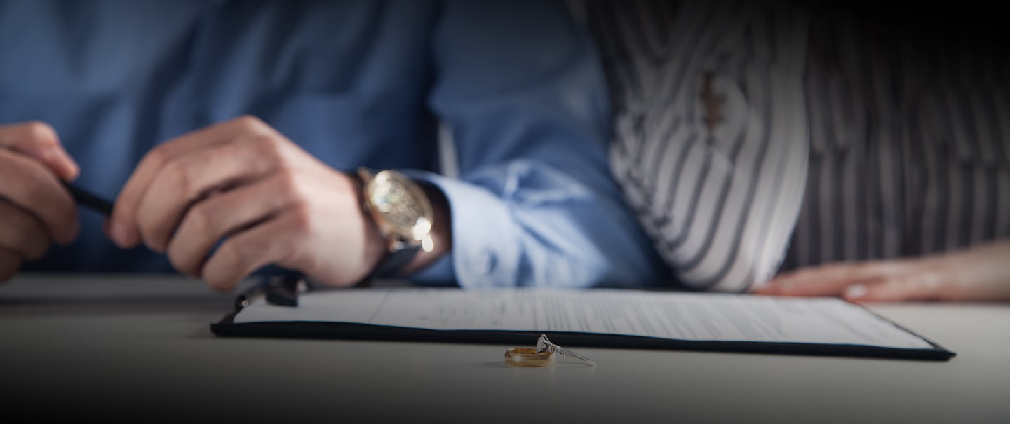 Couple with divorce contract and ring on desk. Divorce and separation.